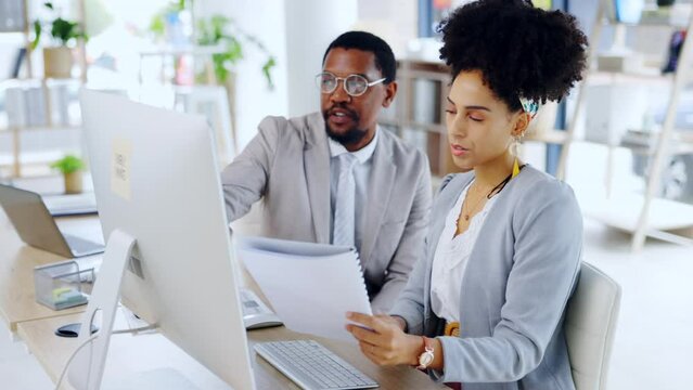 Business people, computer and documents in teamwork planning, corporate strategy or collaboration at the office. Businessman and woman discussing project plan, paperwork or company analysis on PC