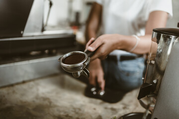 barista girl show ground  coffee in bottomless portafilter. coffee concept.