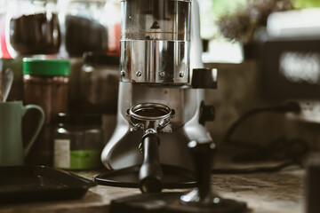  bottomless filter with grinder machine at coffee shop. coffee maker concept.