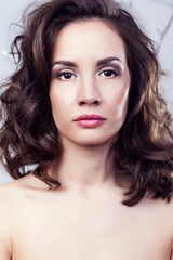Fototapeta premium Portrait of gorgeous woman on grey background in studio photo. Professional make up and hairstyle. Elegance and romance