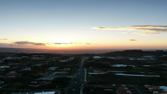 Drone footage of San Jose, Costa Rica. Cars driving towards beautiful sunset in mountains. Vertical aspect aerial video.