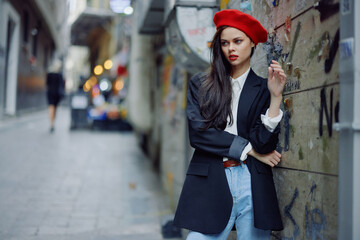 Fashion woman portrait walking tourist in stylish clothes with red lips walking down narrow city street, travel, cinematic color, retro vintage style, dramatic.