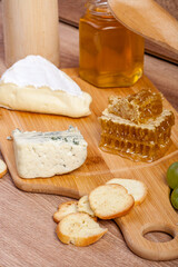 Healthy food. Differet type of cheese on wooden background. Gourmet delicatessen