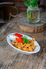 Delicious Fried Crispy Chicken Made from Breast and Skin's Chicken on White-Oval Plate