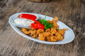 Delicious Fried Crispy Chicken Made from Breast and Skin's Chicken on White-Oval Plate