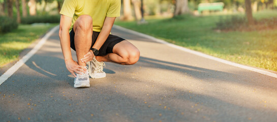 Young adult male with his muscle pain during running. runner man having leg ache due to Ankle...