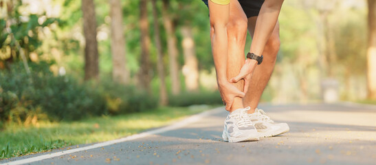 Young adult male with his muscle pain during running. runner man having leg ache due to Shin...