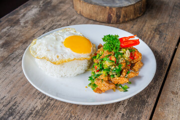 Delicious Salt Pepper Chicken or Ayam Cabe Garam with Fried Egg on Steam Rice