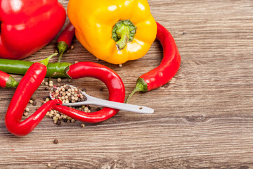 Healthy food. Red and green pepper on wooden background