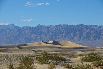 The Mesquite Flat sand dunes rise above Stovepipe Wells in Death Valley, with the Panamint Range and Grapevine Mountains rising aove the valley on both sides.