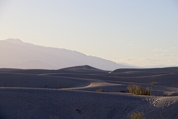 The Mesquite Flat sand dunes rise above Stovepipe Wells in Death Valley, with the Panamint Range...
