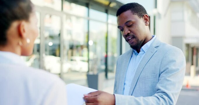 Sales, insurance and businessman or salesman talking to a client explaining using a clipboard outdoors in a city or town. Advice, explain and male agent having a conversation in the street
