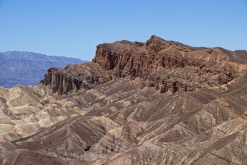 Various colored layers of rock, the result of millions of years of sediment collection, are visible from Zabriskie Point in Death Valley National Park