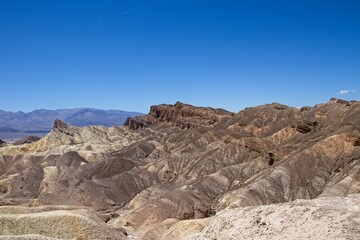 Fototapeta na wymiar Various colored layers of rock, the result of millions of years of sediment collection, are visible from Zabriskie Point in Death Valley National Park