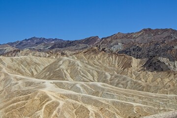 Various colored layers of rock, the result of millions of years of sediment collection, are visible from Zabriskie Point in Death Valley National Park