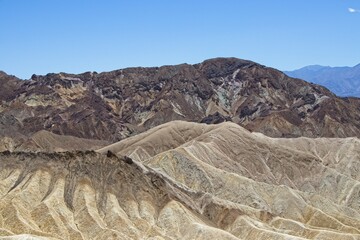 Various colored layers of rock, the result of millions of years of sediment collection, are visible from Zabriskie Point in Death Valley National Park