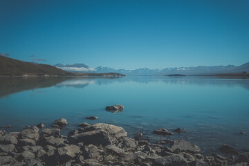 Stones in large green lake, New Zealand. Lake Wanaka