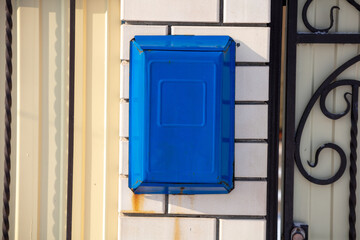 Mailbox on the brick wall of the house.