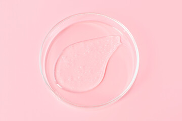 Smear of shower gel or shampoo on pink background close-up top view.