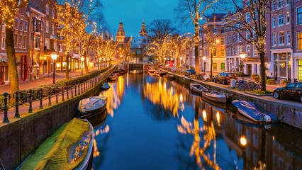 Fototapete Amsterdam Amsterdam Netherlands canals with Christmas lights during December, canal historical center of Amsterdam at night. Europe