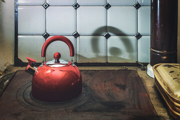 Modern teapot on top of antique cheap stove top