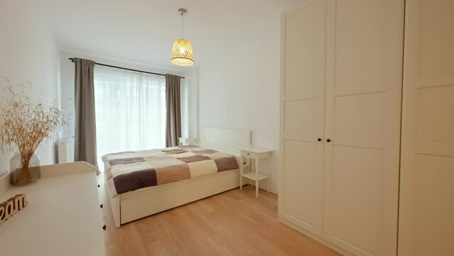 Forward shot entering a luxury apartment modern bedroom, with white and neutral colors furniture