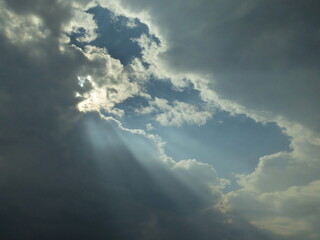 Sun rays from sun behind the clouds before storm