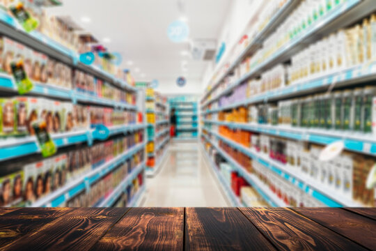 Grocery table background. Blurred supermarket shelves with goods and products. Product demonstration concept. 