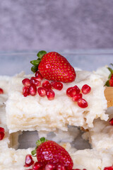 Gullac dessert. Traditional Ramadan dessert. Close-up of gullac dessert with pomegranate and strawberry