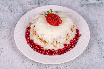 Gullac dessert. Traditional Ramadan dessert. Gullac dessert with pomegranate and strawberry on the plate