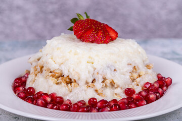 Gullac dessert. Traditional Ramadan dessert. Gullac dessert with pomegranate and strawberry on the plate. Close up