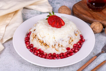 Gullac dessert. Traditional Ramadan dessert. Gullac dessert with pomegranate and strawberry on the plate