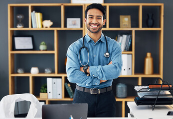 Portrait, healthcare and man with arms crossed, hospital and happiness with development, medicine and research. Face, medical professional and happy male employee with confidence, wellness or success