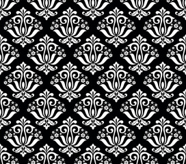 Wallpaper in the style of Baroque. Seamless vector background. White and black floral ornament. Graphic pattern for fabric, wallpaper, packaging. Ornate Damask flower ornament