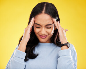 Young woman, stress and headache with pain and distress, frustrated and agony on yellow studio background. Female massage temple, mental health and anxiety with depression, migraine and trauma