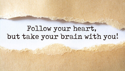 Follow your heart, but take your brain with you. Words written under torn paper. Motivation concept...
