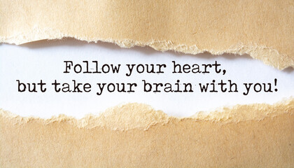Follow your heart, but take your brain with you. Words written under torn paper. Motivation concept text