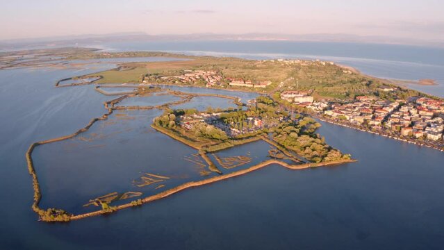 4K aerial - a bird's eye view&nbsp;video (Ultra High Definition) of fish farms in outscirts of Grado town location, Italy, Europe. Exotic evening seascape of Adriatic sea. Traveling concept background.
