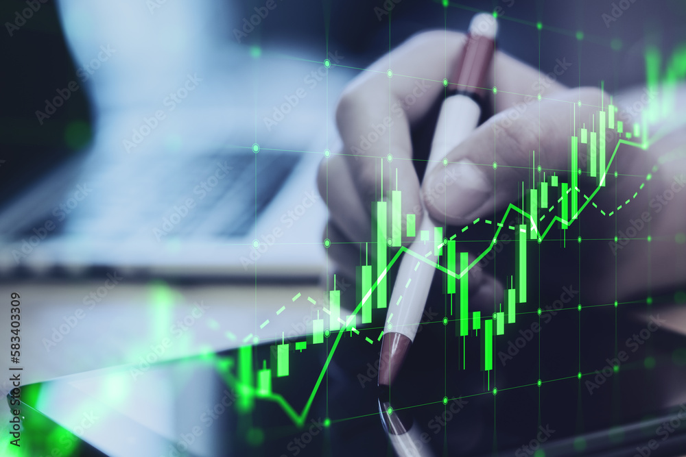 Poster close up of hand using digital tablet with pen and growing green candlestick chart on blurry desktop