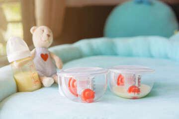 Electronic pump full with bottle of mother breast milk, breast milk storage and handling concept.selective focus.