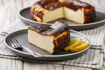 Restaurant style famous burnt San Sebastian cheesecake close-up on a plate on the table. Horizontal