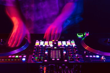 Fototapeta na wymiar Close up of DJ hands on dj console mixer during concert in the club