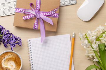 Desk with a gift and flowers
