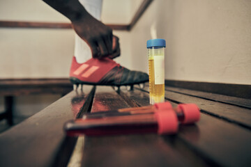 Rugby, blood and urine sample in a locker room for sports regulations or anti doping testing. Fitness, health and medical with an athlete getting ready after a drug test for an illegal substance - obrazy, fototapety, plakaty