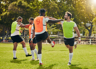 Sports, rugby men and training outdoor on grass field with team stretching legs as warm up. Male athlete group together for fitness, exercise and workout for sport with support and club teamwork