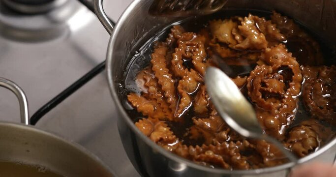 The final act unfolds as each crispy chebakia is lovingly dipped into warm honey, a transformative step for a perfect finishing touch
