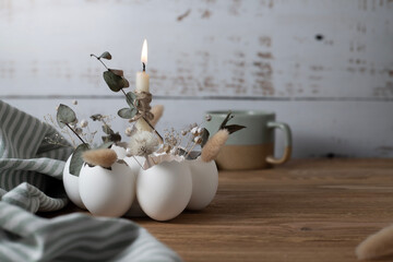 Easter decor in the form of eggs, flowers nearby