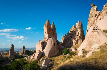 Naklejka premium Cappadocia ancient ruins of cave houses cut in cone shaped rock formations in Uchisar, Goreme National Park, Turkey