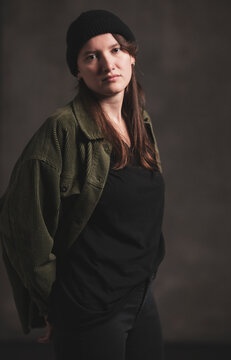 Studio Image of mid twenties girl, with half shaved head and with hat on