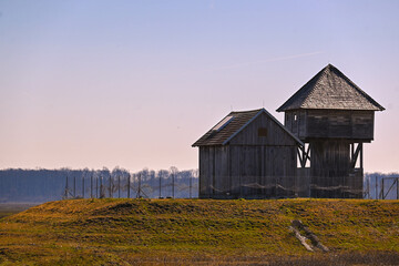 Obraz premium An inviting wooden bird watching house perched amidst the verdant beauty of Osekovo in Lonjsko polje, beckoning nature enthusiasts to explore its lush surroundings.